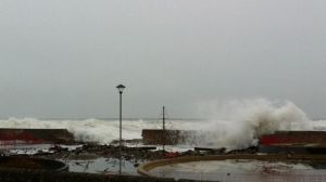 Waves overtopping the sea wall at Lossiemouth during the December 2012 storm, causing severe structural damage and flooding a park.